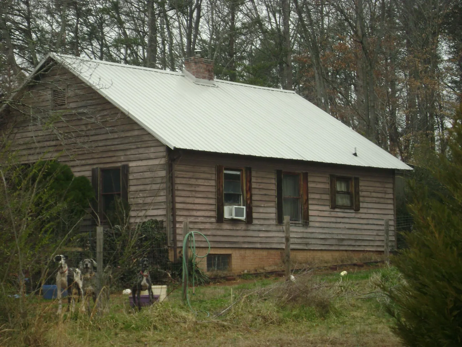 White metal roof on an old wood sided farmhouse, from a Metal Roof Installation job in Melville