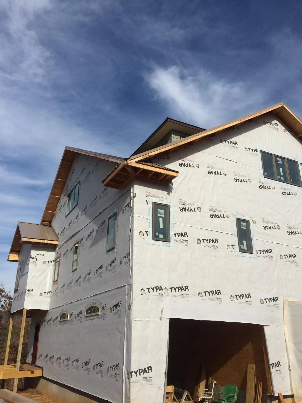 Stick built house wrapped in Typar with new roof framing and dormers in Melville